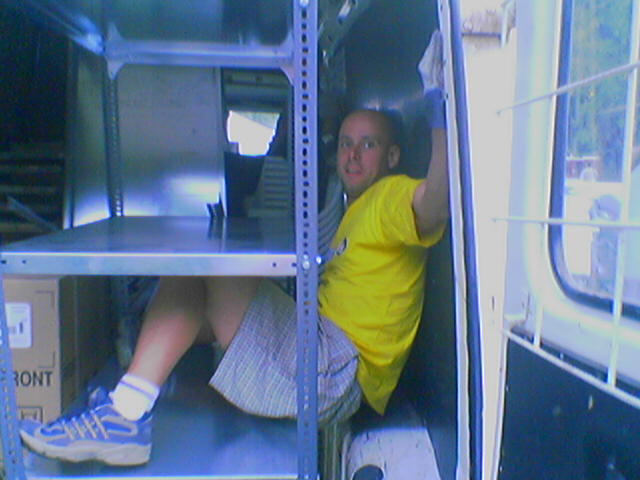 Sziget Festival 'Backstage-boy' stuck between furniture in a van. Funny picture about working at the largest festival in Europe.