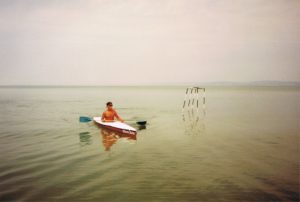 DXN coffee MLM networker is kayaking at Lake Balaton, the Hungarian Sea