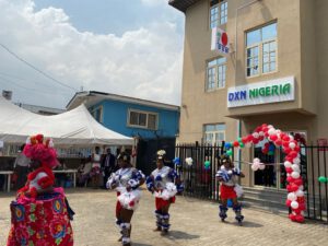 Nigerian dancers at DXN Lagos office opening ceremony in front of office building